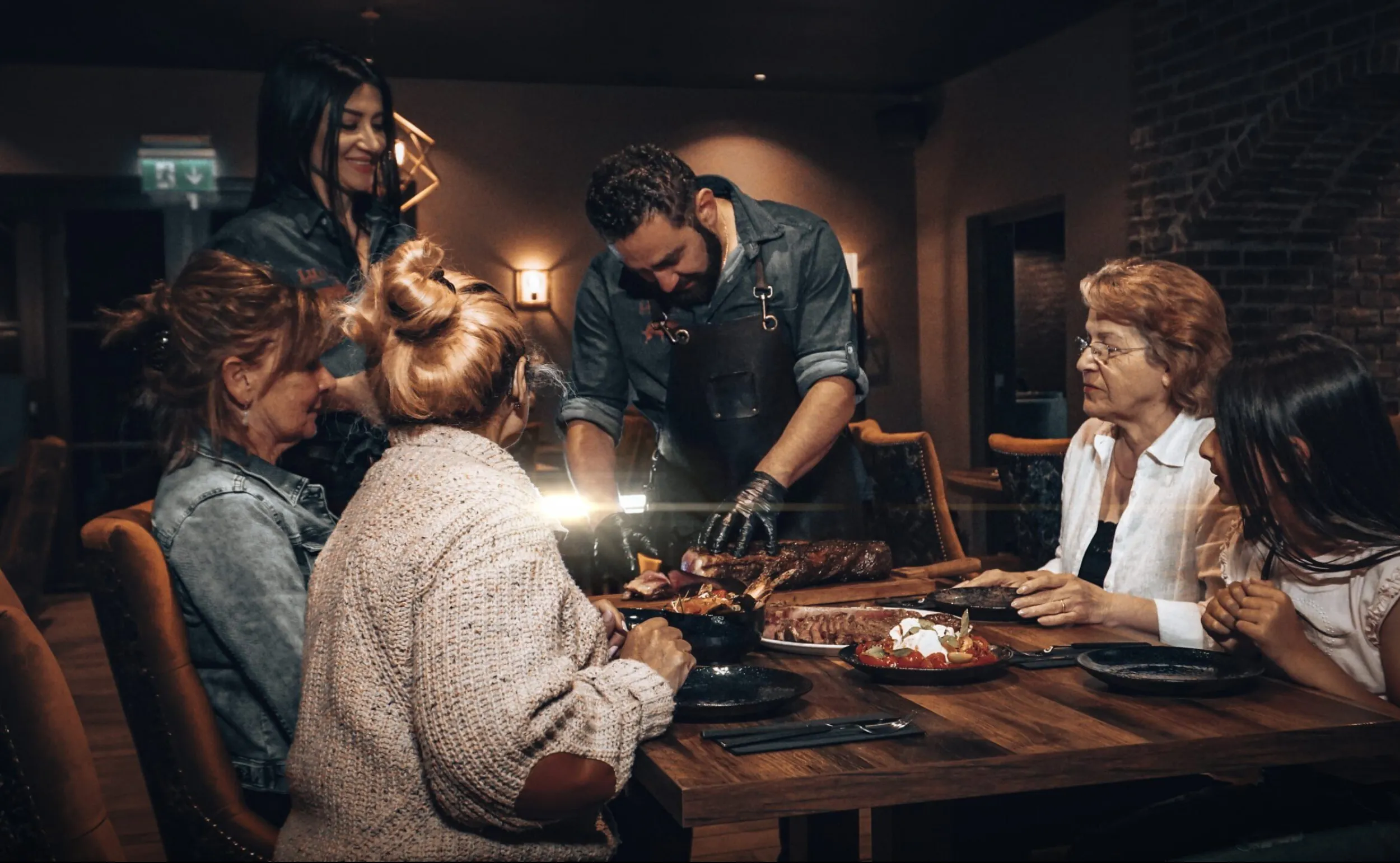 Man snijdt biefstuk aan tafel.