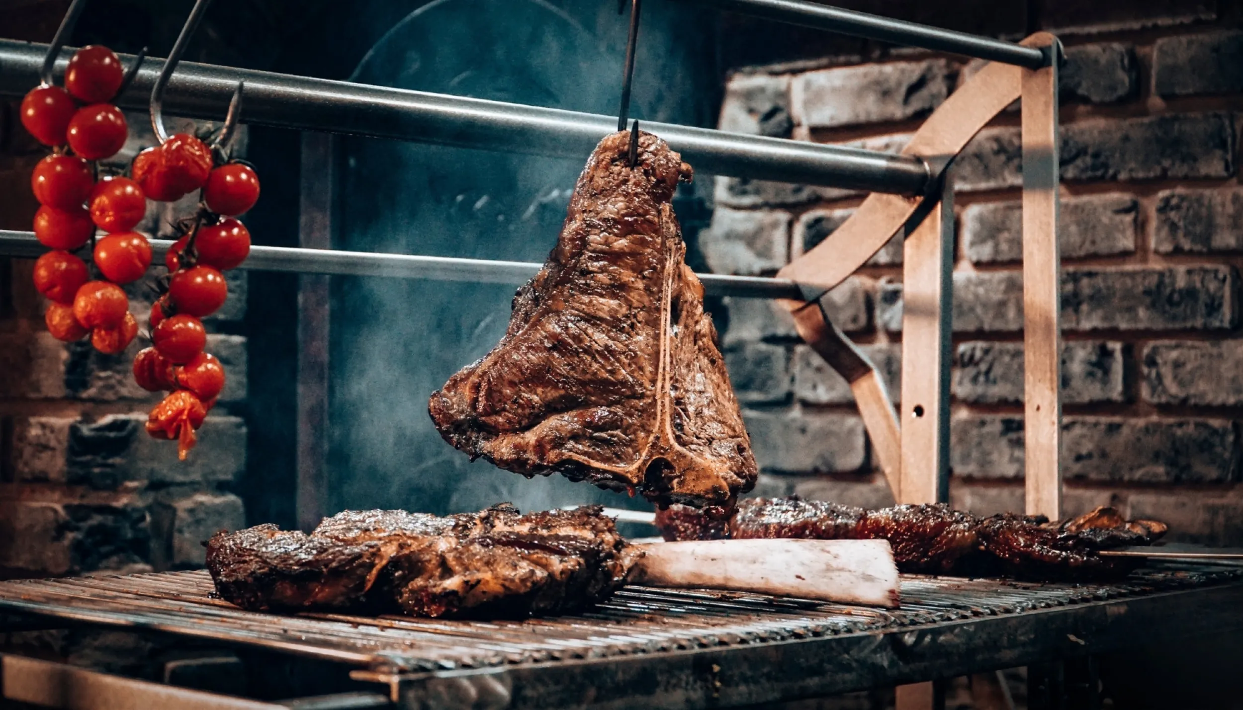 A piece of meat is hanging over the grill